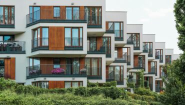 Modern serviced apartments exterior like Ebenezer Hotel Apartments in Kigali, featuring balconies and secure residential design near Kigali International Airport.